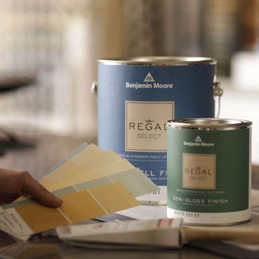 benjamin moore yellow & green color chips featured beside a gallon of regal select paint and a quart of regal select paint